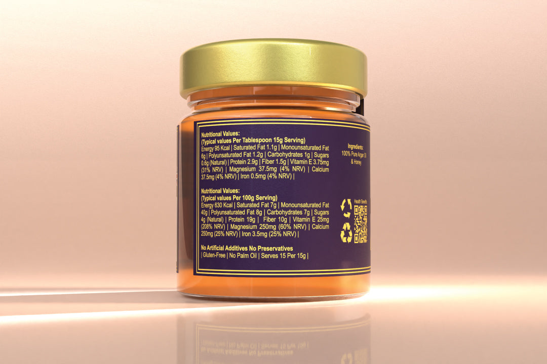 Jar of honey with a gold lid on a reflective surface and light pink background